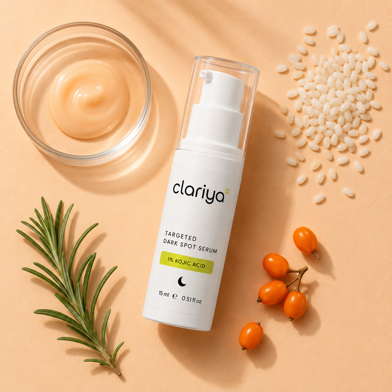 Overhead flat-lay of the CLARIYA serum bottle beside a glass dish of peach serum, koji rice grains, a rosemary sprig and sea-buckthorn berries on a warm peach background.